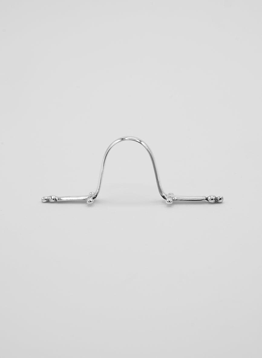 A sterling silver face jewelry piece. Worn like a nose clip—piercing-free jewelry—with beautiful handcrafted details