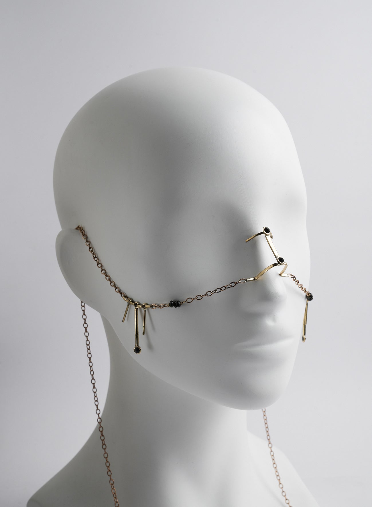 bridge nose type jewelry with chains and pendants.
