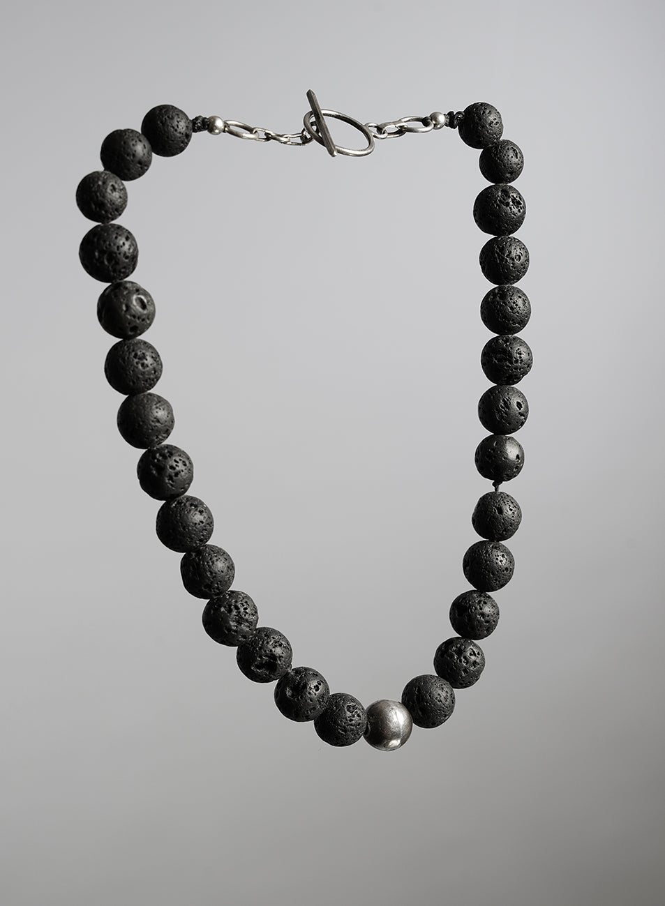 short necklace with black volcanic beads and silver  