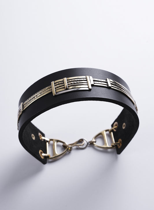 A genuine leather choker necklace with a geometric pattern. 