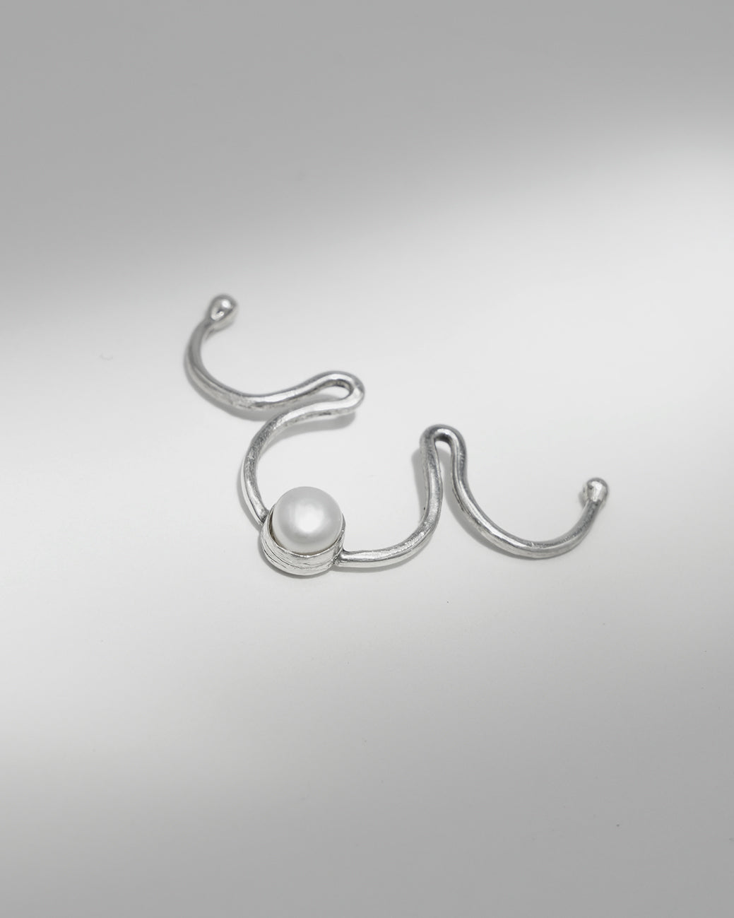 Handcrafted silver fake septum ring with genuine pearl.