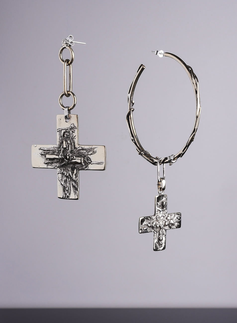 pair of asymetrical XL earrings with cross pendant