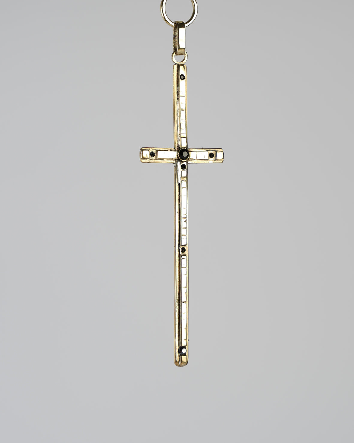beautiful sculptural golden cross, handmade, decorating a unique choker necklace