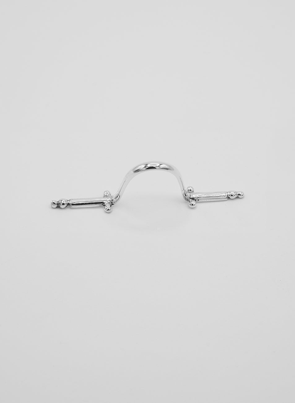 A silver facial jewelry accessory that is worn on the nose. Made up of small beads details. 