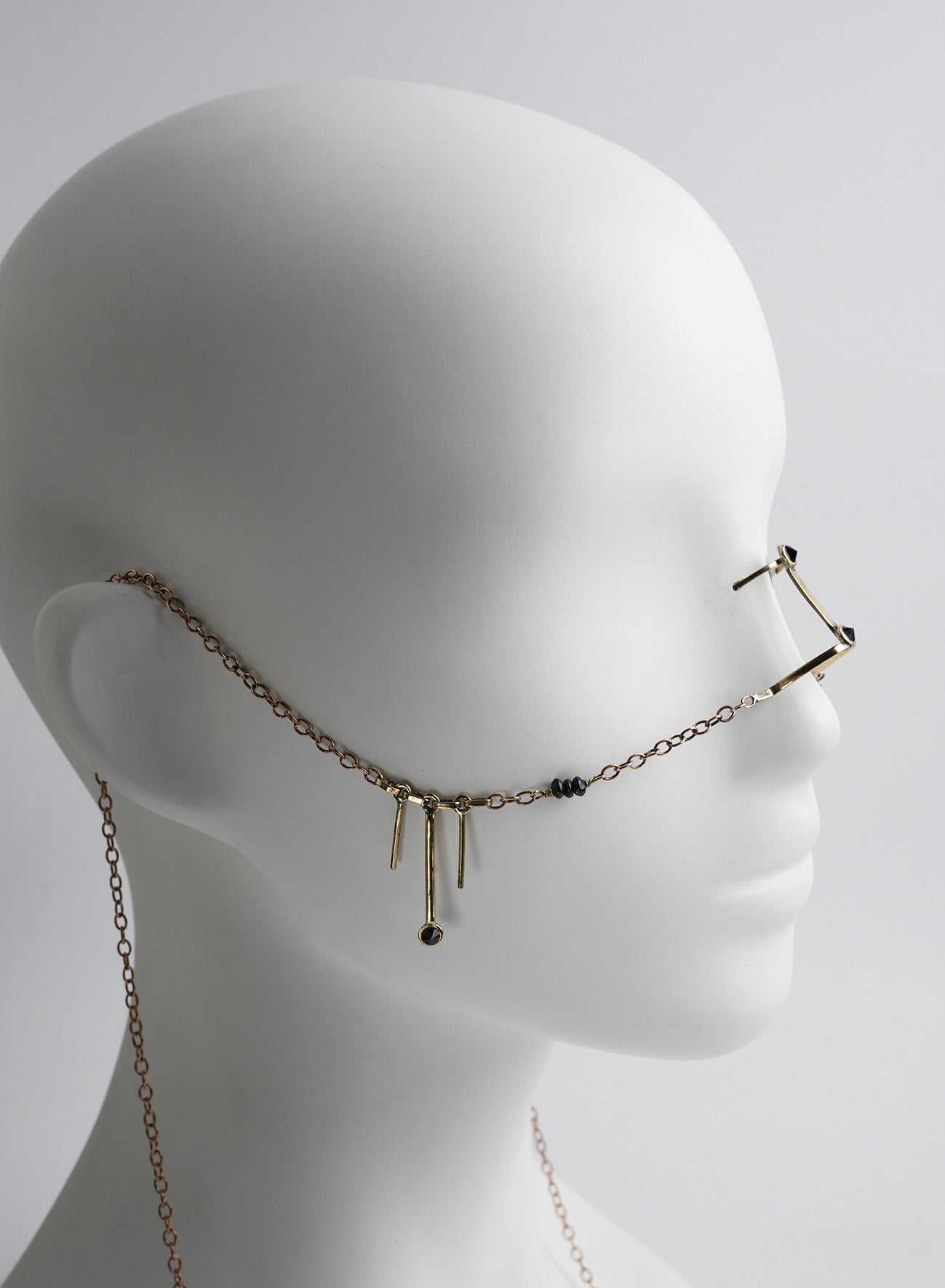 bridge nose jewelry with chains, pendants and gems.