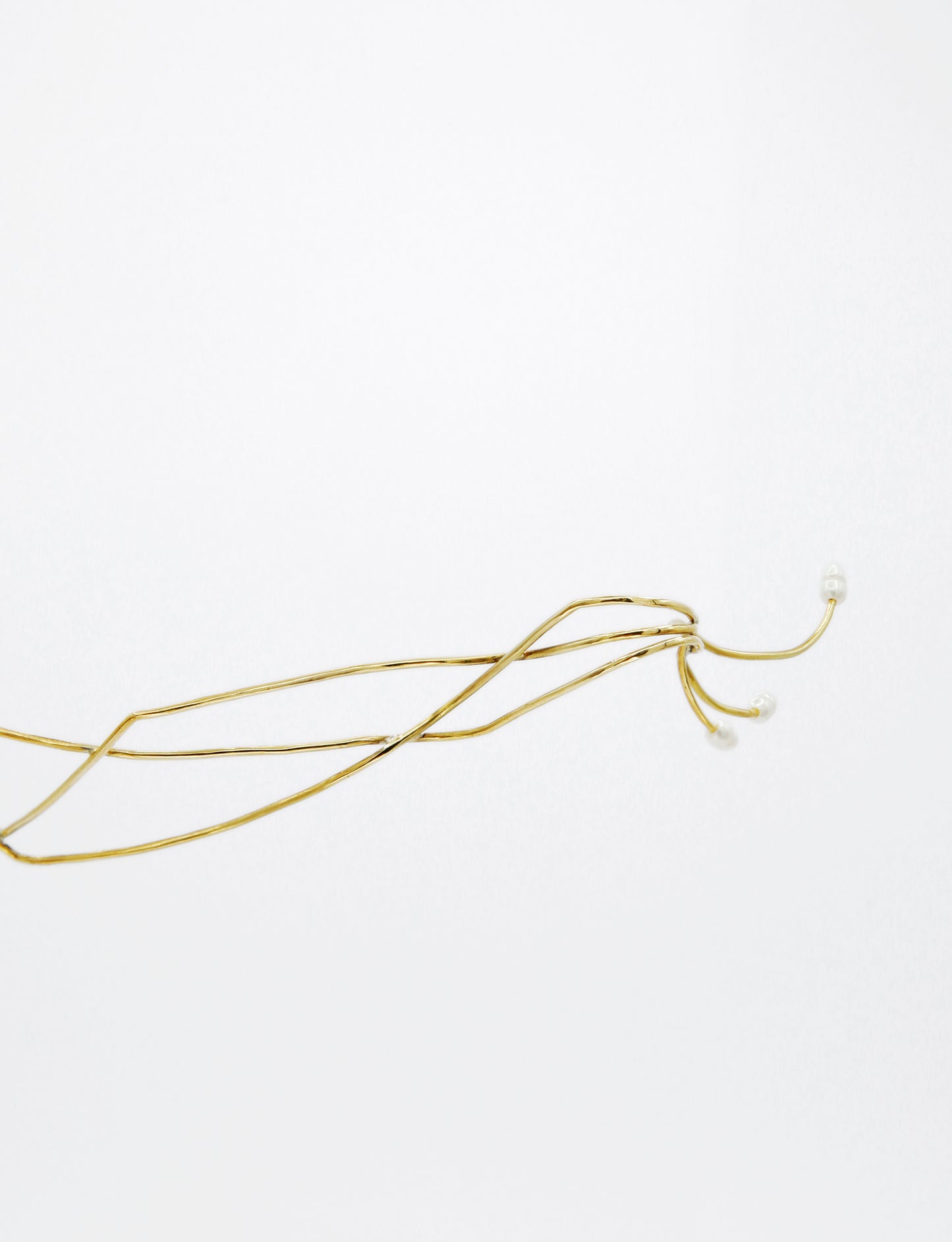 contemporary golden jewelry, shaped for the face to beautify 