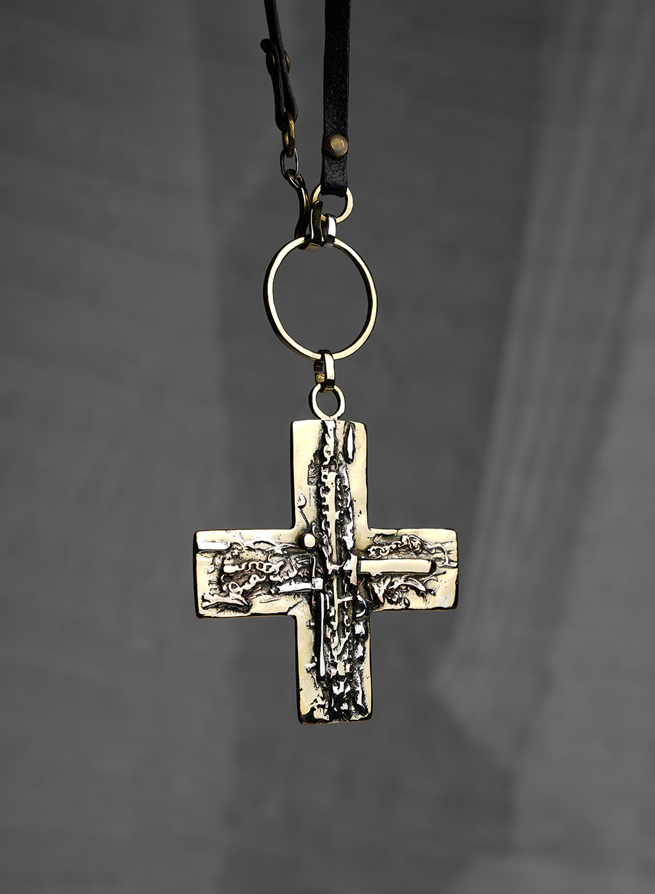 long necklace with gold and silver cross sculpted pendant 