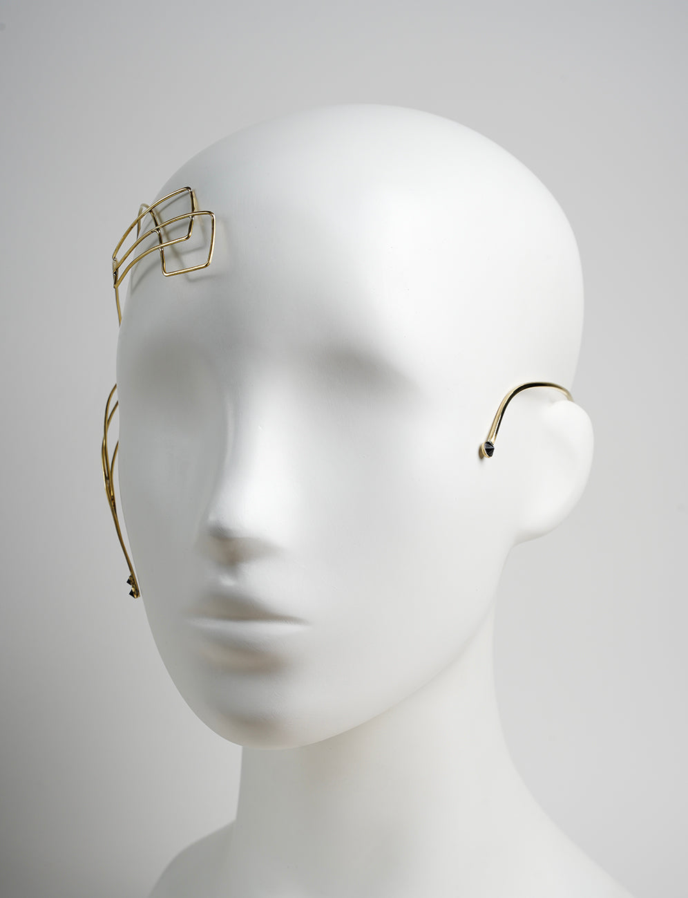 gold face ornament with black Swarovski crystals