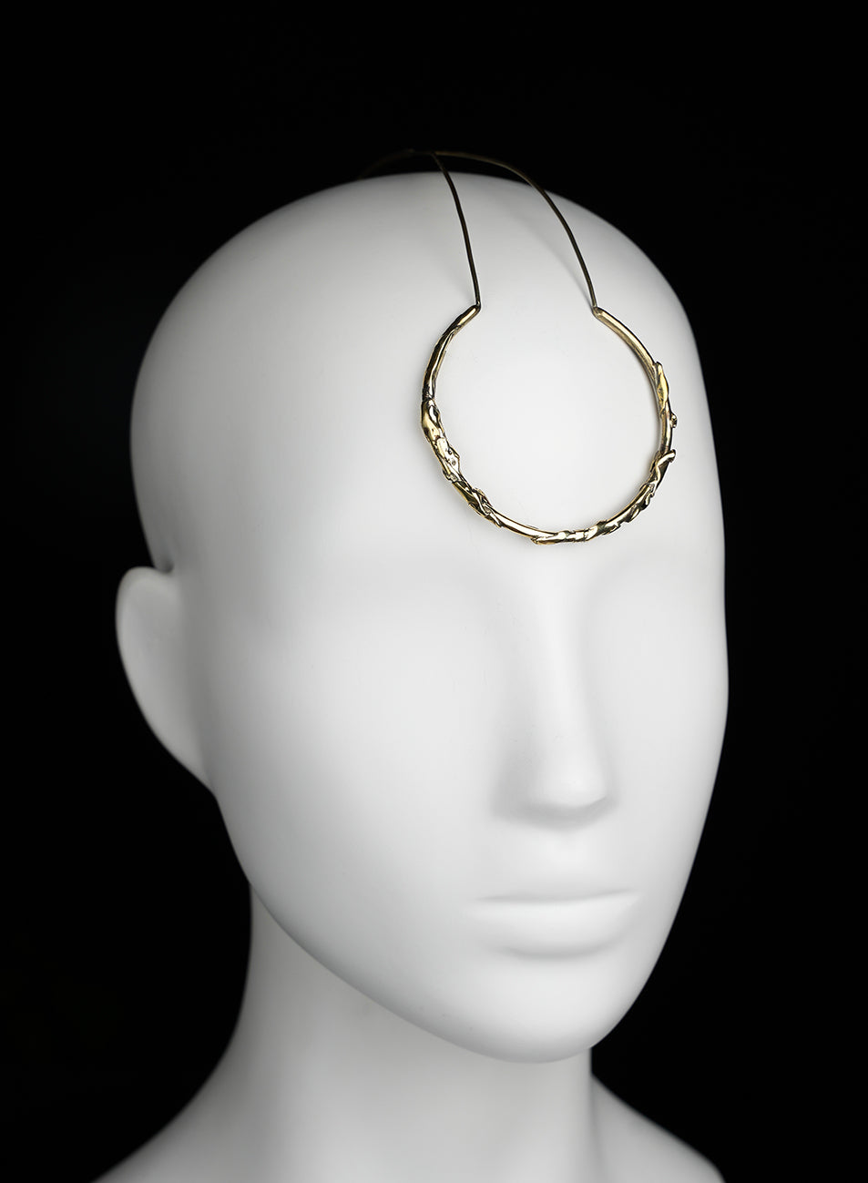 a golden piece of jewelry that enhance the face 