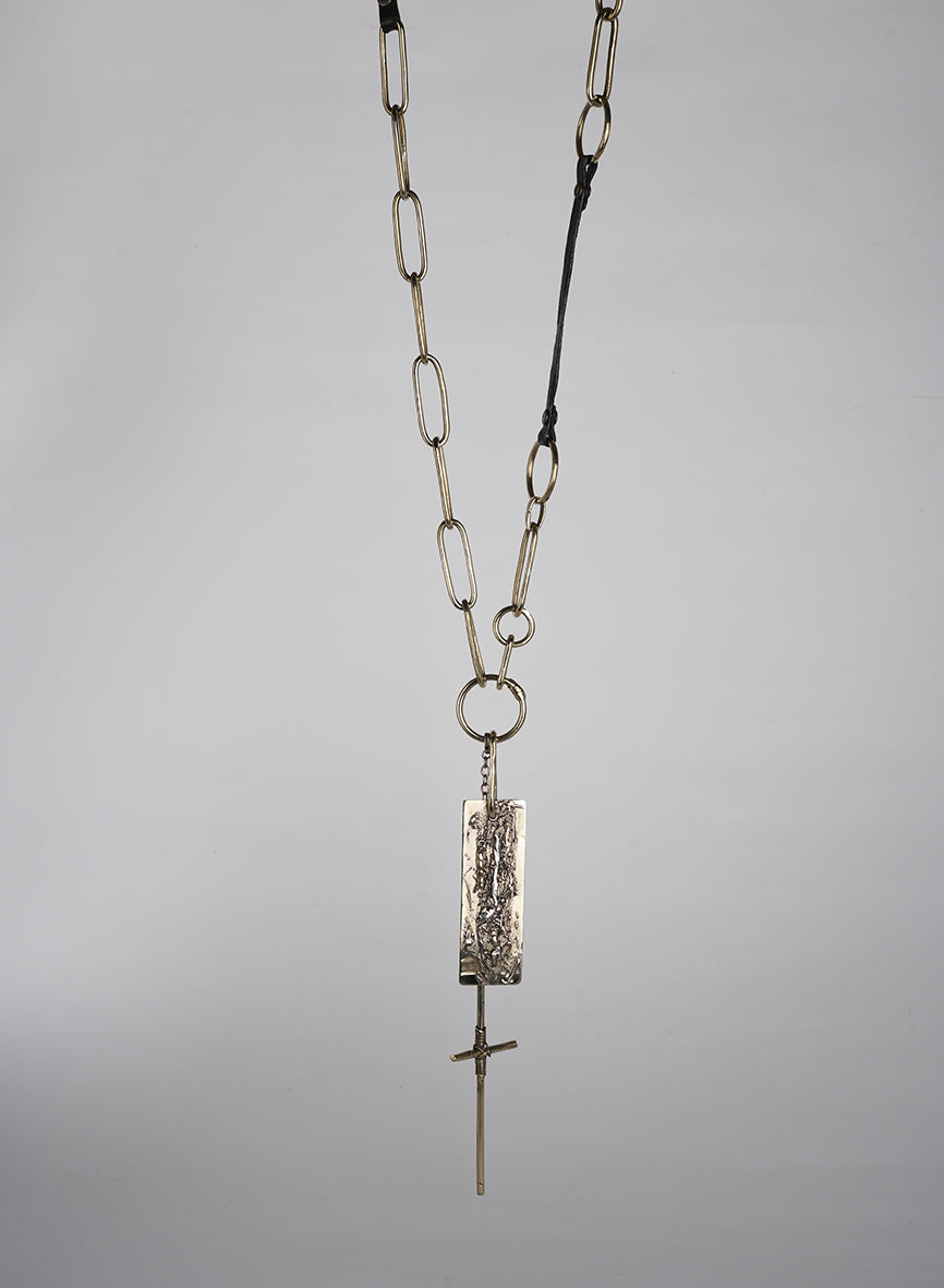 Long necklace handmade from jewelry designer made of leather and gold-tone metal with cross pendant and embellishment