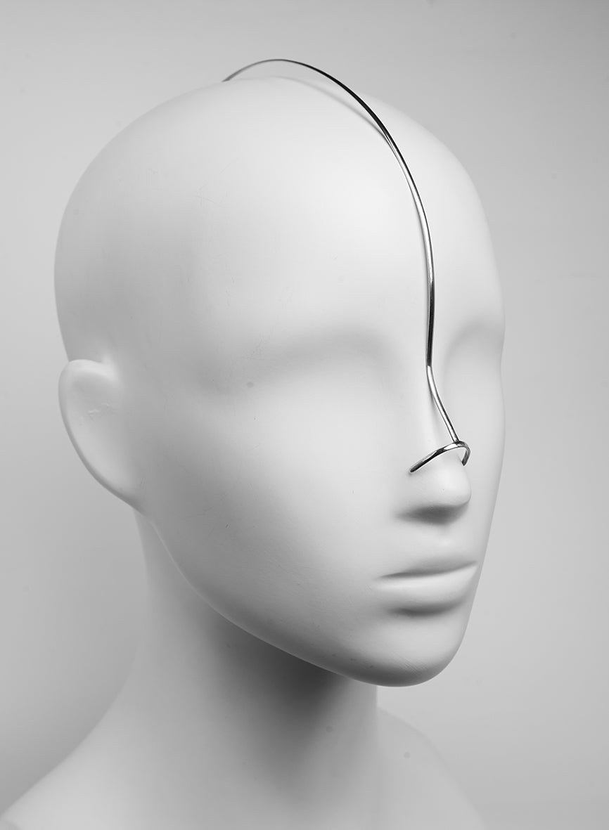 A minimalist piece of jewelry that hugs the contours of the face to enhance its beauty