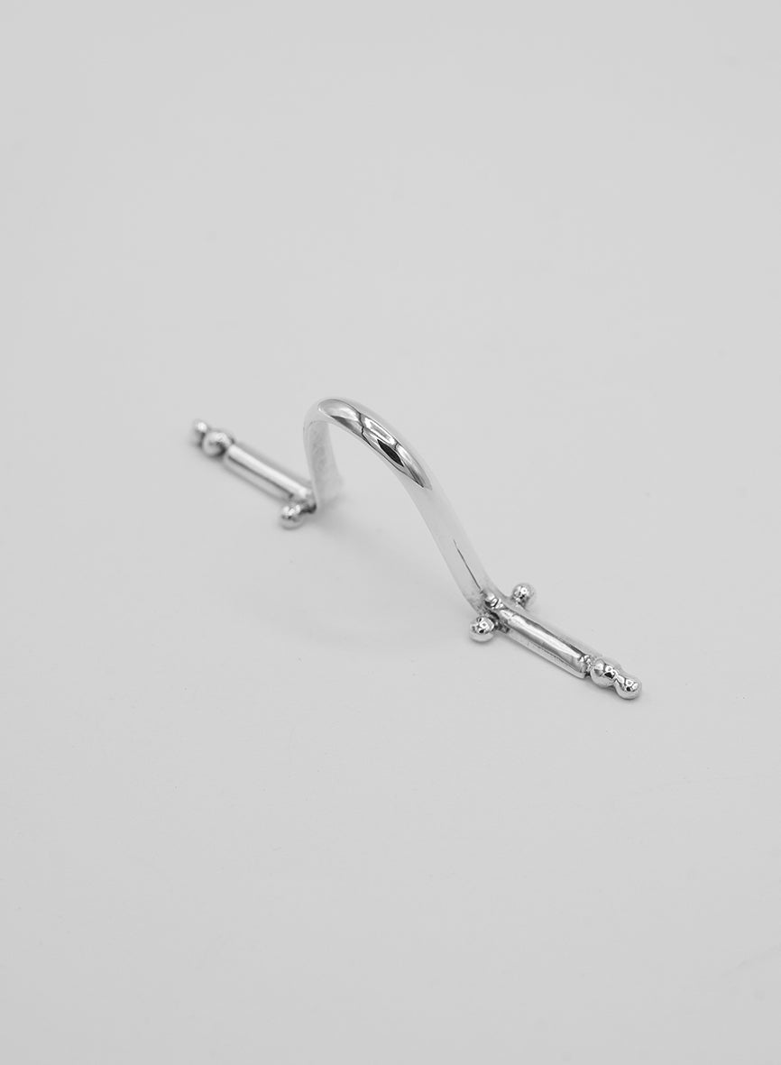 a unique piece of jewelry in silver that clips onto the nose