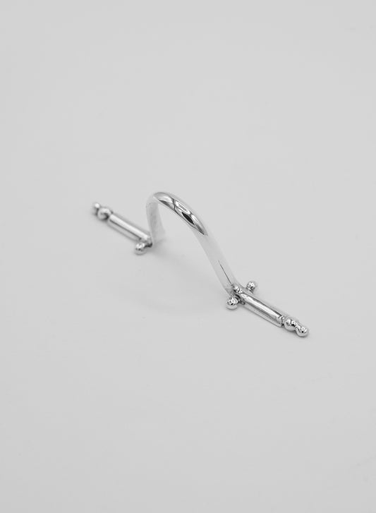 a unique piece of jewelry in silver that clips onto the nose