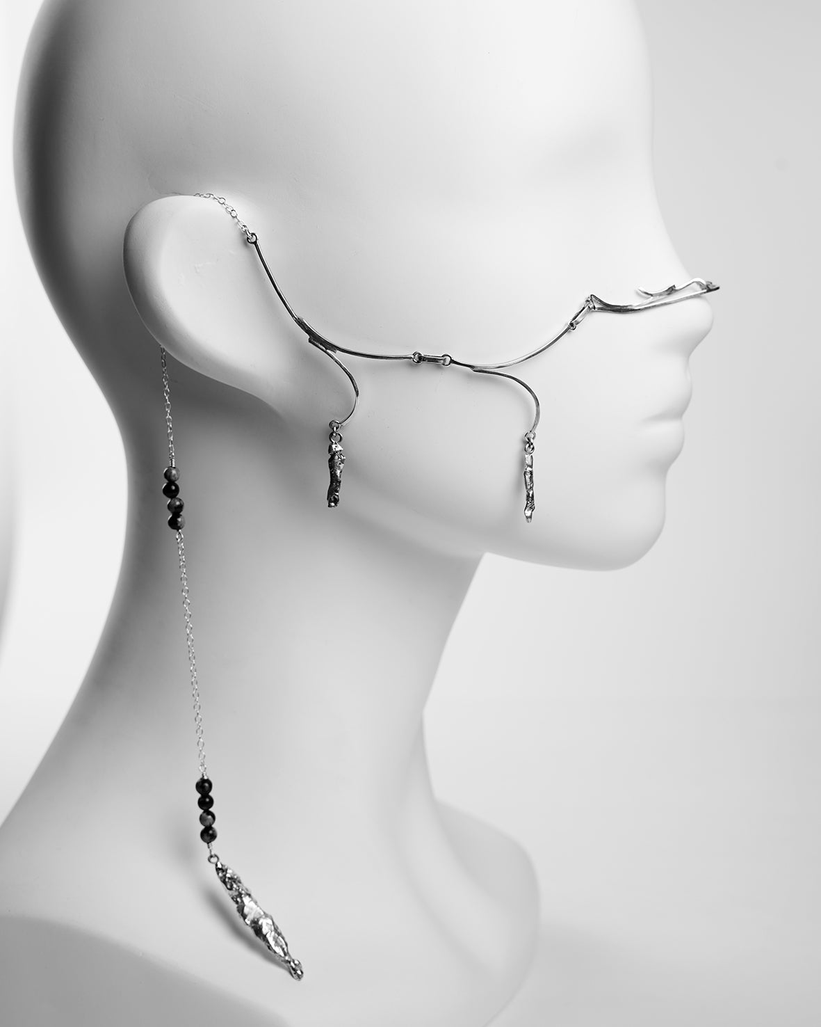 asymetrical face jewelry, clip on the nose with a single silver chain and pendants 