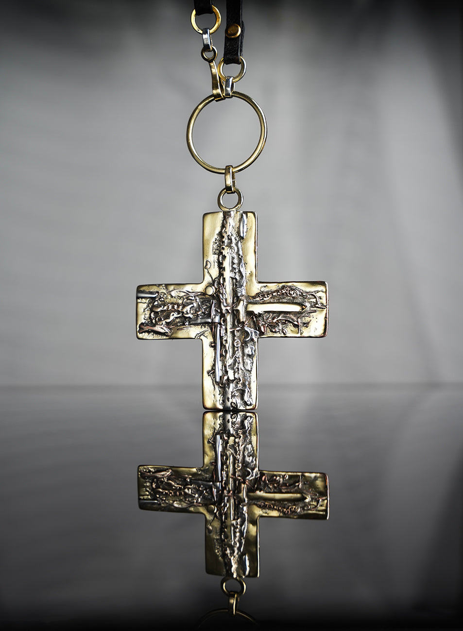 Beautiful necklace, using leather, gold and silver. The cross pendant is a true and unique work of art