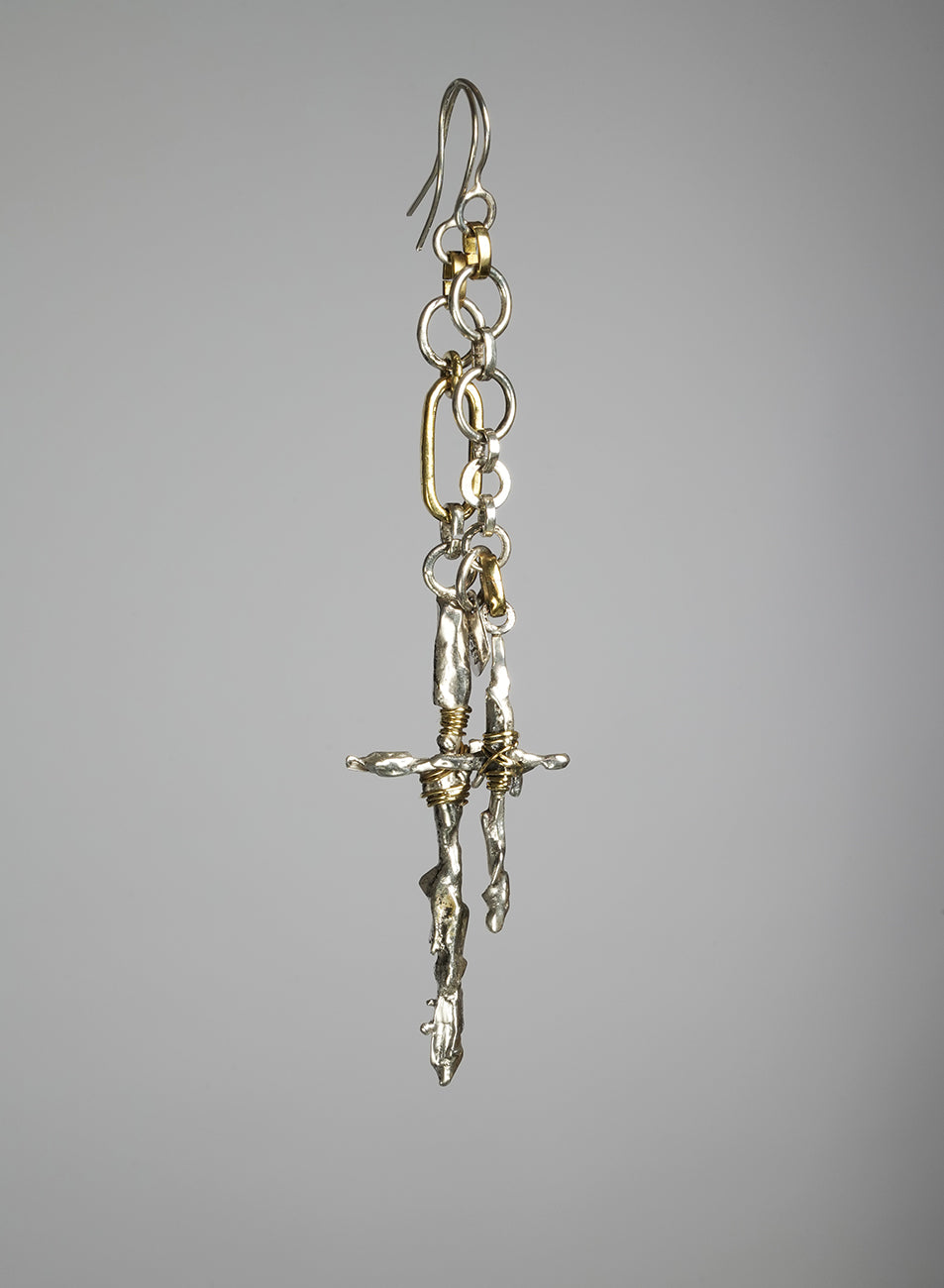 handcrafted pair of asymmetrical earrings with cross pendant