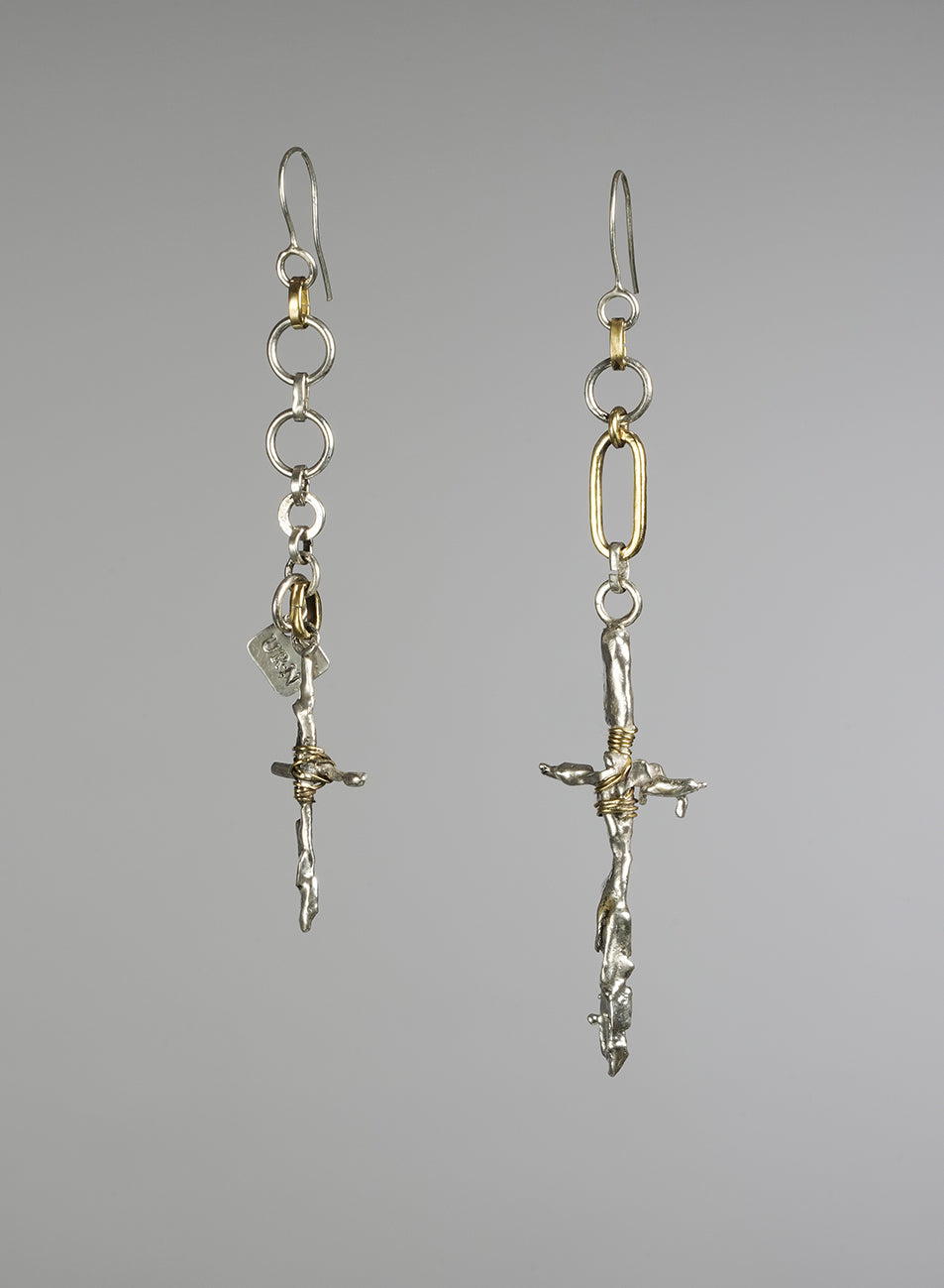 pair of unique asymmetrical  earrings, gold color and silver. 