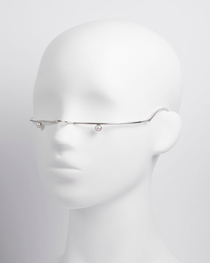 elegant piece of facial jewelry with clean lines and a minimalist, futuristic design 
