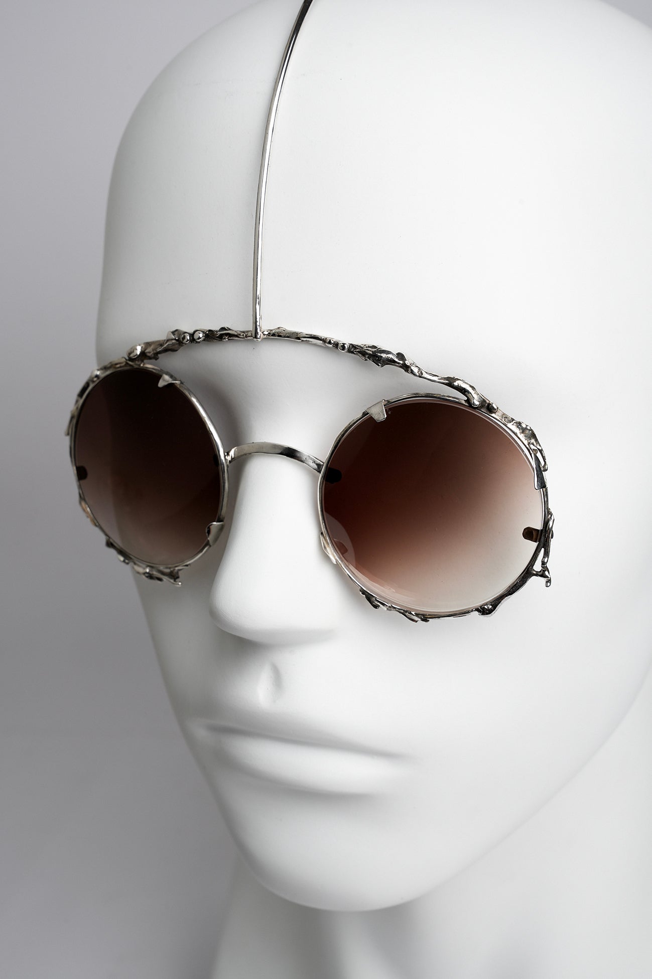 modern and futuristic sunglasses worn like a face jewelry unique piece