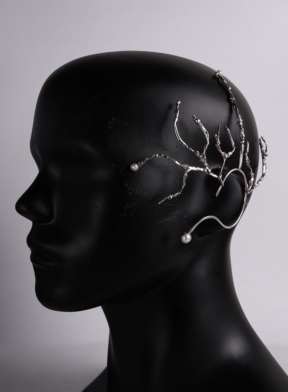 a magnificent, extravagant piece of silver ear jewelry 